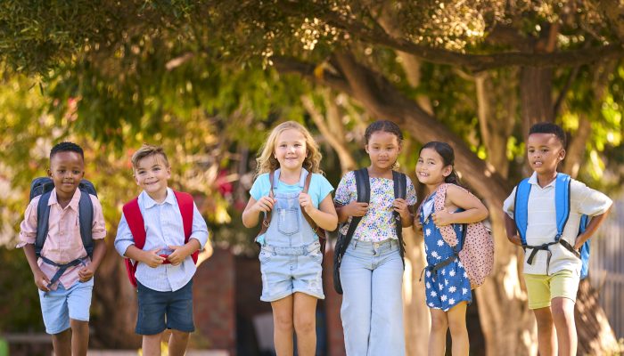 Portrait Of Multi-Cultural Primary Or Elementary School Students Outdoors At End Of Day